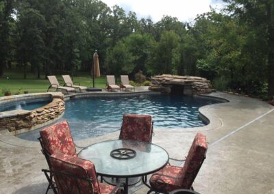 beautiful pool area with custom stone work