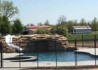 pool with custom stone work and slide