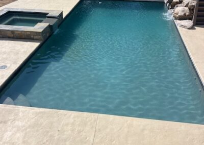 Pool with a slide and hot tub